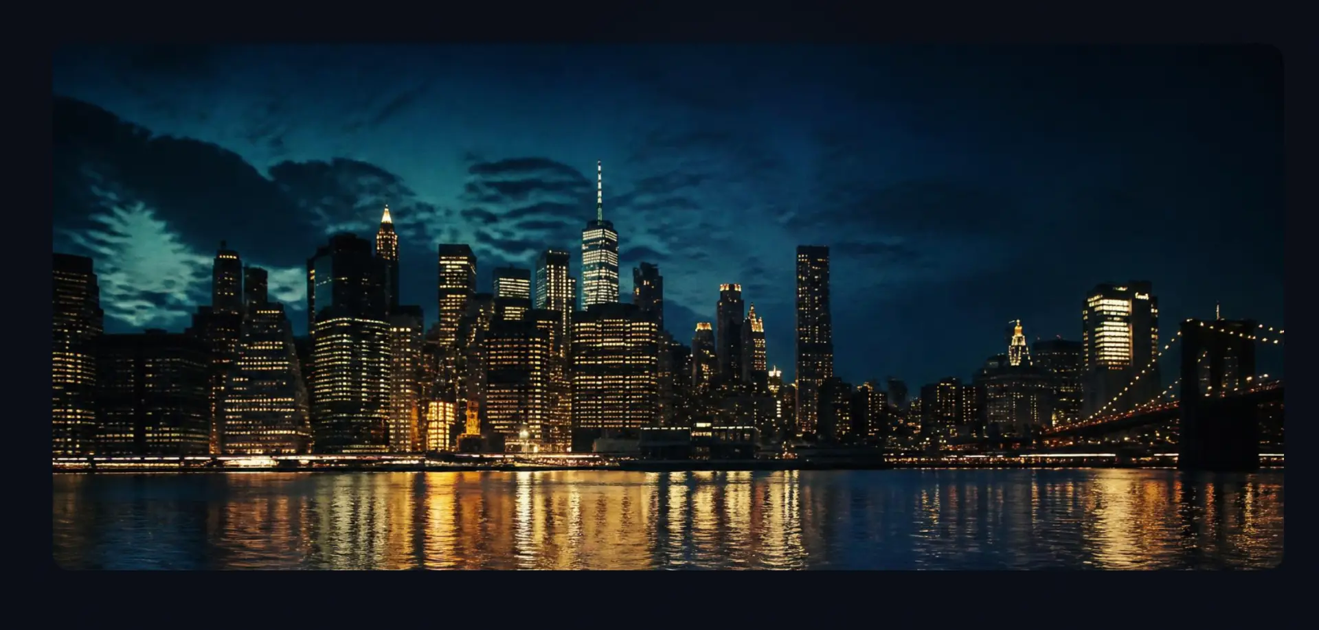 Manhattan skyline at night seen from Brooklyn, amber lights reflecting on the East River