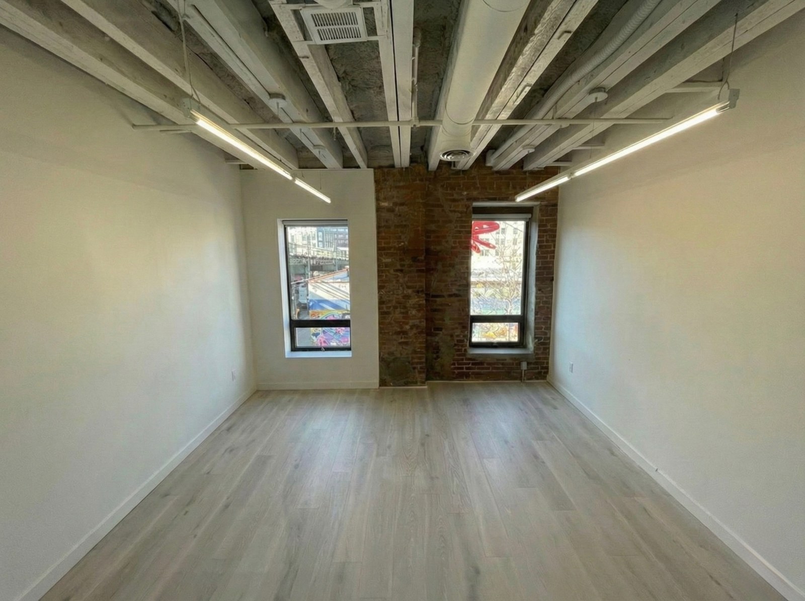 Private suite with exposed brick and tall windows